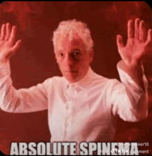 a man in a white shirt is holding his hands up with the words absolute spin written below him