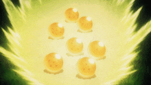 a group of dragon balls are surrounded by a green light