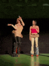 a man and a woman are dancing on a stage in front of a crowd .
