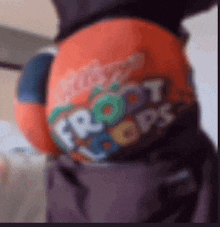 a blurred image of a person wearing a shirt that says fruit loops on it