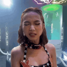 a woman with her eyes closed is wearing a choker necklace