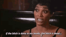 a woman is sitting in a chair and says if the bitch is done in my books the bitch is dead .