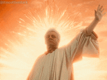 a man in a white robe with his arm outstretched is surrounded by fireworks