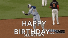 a baseball player is celebrating his birthday on the field while another player watches .