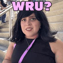 a woman wearing a black top and a lanyard that says wru