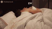 a man laying in a bed with the word ew on the bottom