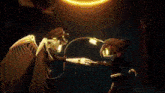 a person is holding a sword in a dark room with a glowing light behind them .