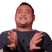 a man in a blue sweater is clapping his hands and smiling