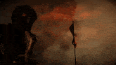 a person wearing a gas mask stands in front of a flag
