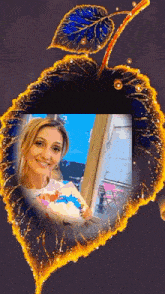 a woman is smiling in a picture frame with a leaf in the background