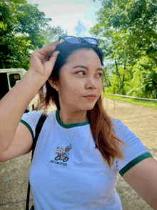 a woman wearing a white t-shirt with the word decorative on it