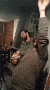 a man is holding a bottle of lite beer in his hand