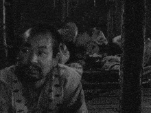 a black and white photo of a man laying down