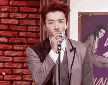 a man in a suit singing into a microphone