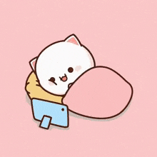 a cartoon cat is laying under a blanket with a cell phone .