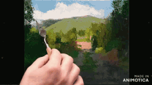 a person is painting a landscape with the words made in animotica on the bottom right