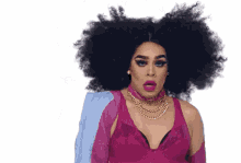 a drag queen is wearing a pink bra and a blue jacket .