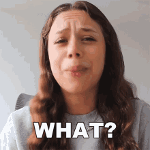 a woman is making a funny face and the words what are above her head