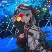 a girl in a video game is holding a red and yellow capsule in her hand .