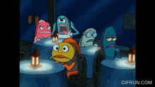 a group of cartoon fish are sitting around a table with a gifrun.com watermark
