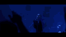 a man singing into a microphone in a dark room