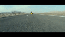a person riding a skateboard down a road