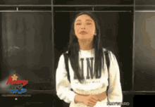 a woman wearing a white sweater that says nn on it