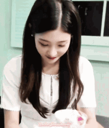 a girl in a white shirt with under strawberry written on the top