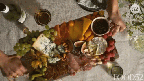 Charcuterie board being placed down on a table GIF