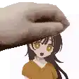 a hand is holding a cartoon character 's head .