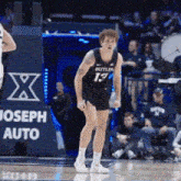 a basketball player wearing a butler jersey stands on the court