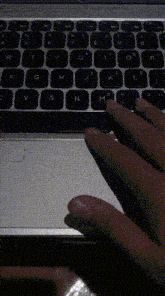a close up of a person 's hand typing on a keyboard