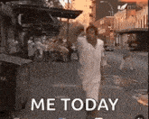 a man in a white shirt is running down a city street .