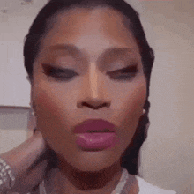 a close up of a woman 's face with pink lipstick and a white shirt .