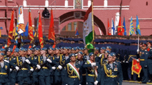 a group of soldiers marching in front of a building