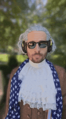 a man in a wig and sunglasses is wearing an american flag scarf around his neck