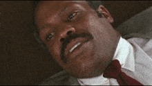 a man in a suit and tie is laying down with his eyes closed and the words i 'm too old for this shit below him