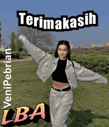a woman in a white jacket stands in front of a sign that says terimakasih lba on it