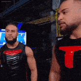 two wrestlers are standing next to each other in front of a screen that says ak