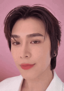 a close up of a person 's face with pink lipstick on their lips