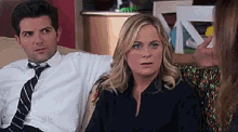 a man and a woman are sitting on a couch .