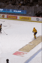 a hockey game is being played in front of a banner that says cayle farms
