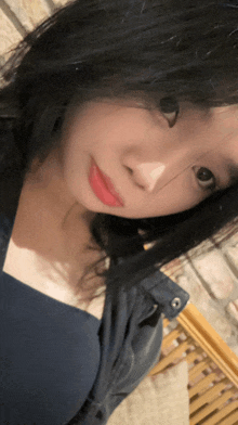 a close up of a woman 's face with black hair and red lipstick