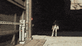 a woman standing in a dark room with a machine that says ' a ' on it