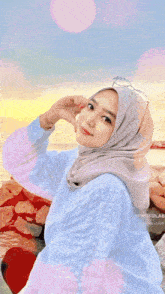 a woman wearing a hijab with the words assalamualaikum salam kenal salam santun semuanya