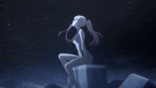 a statue of a woman sitting on a rock looking up at the stars