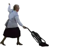 a woman in a white apron is using a vacuum cleaner