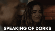 a woman is speaking of dorks in a dark room