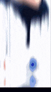 a blurred image of a person 's face with a blue circle in the middle
