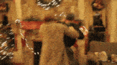a blurry picture of a man and woman dancing in front of a fireplace .